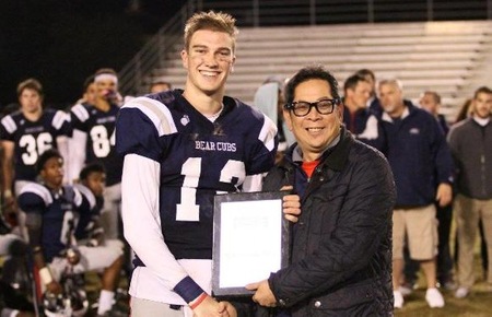 QB Mitch Hood receives his MVP award from SRJC President, Dr. Frank Chong, at the conclusion of the North State Bowl Game. Photo by:  Guy Mohr